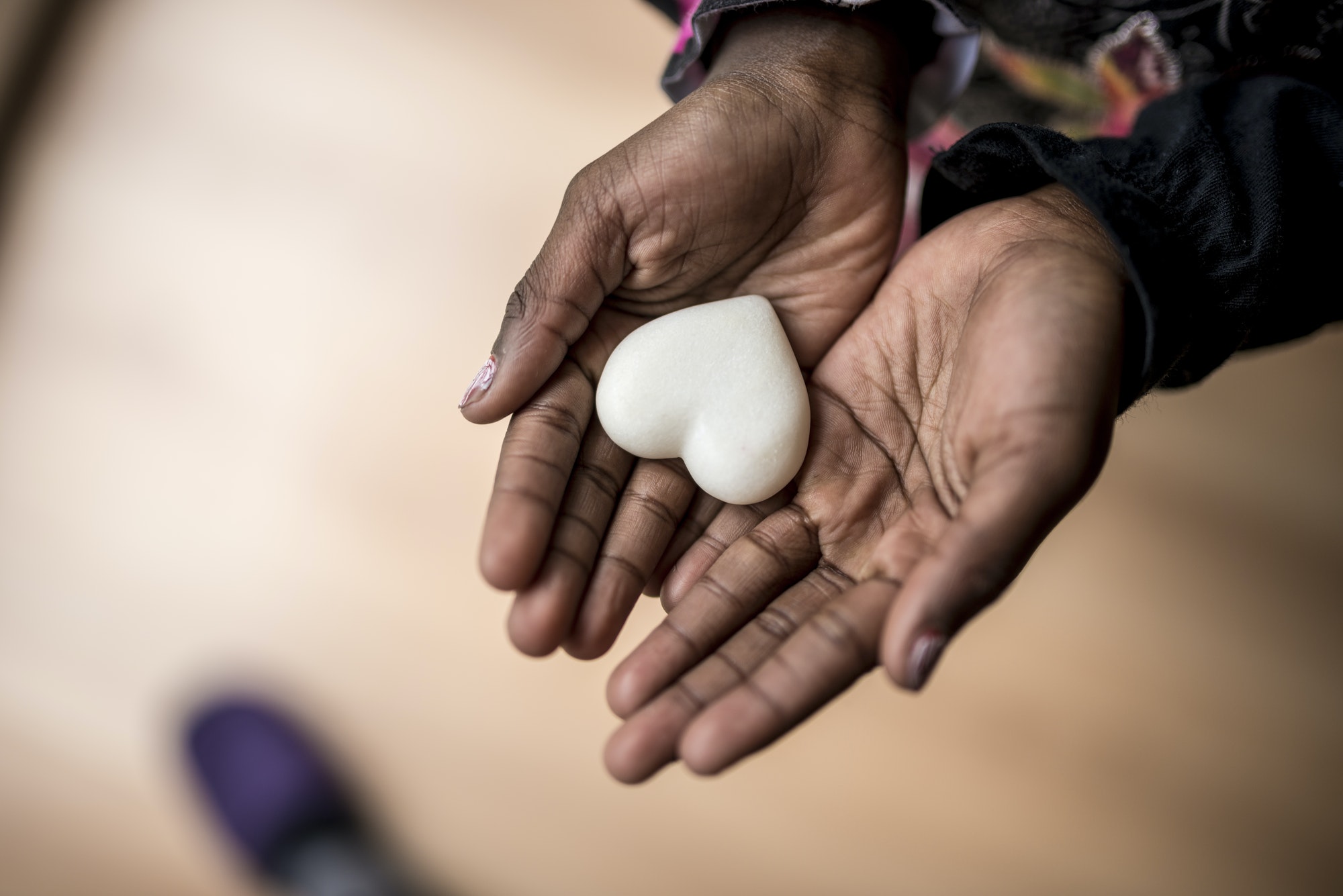 Elementor Programs african american girl hands holding a marble made heart.jpg